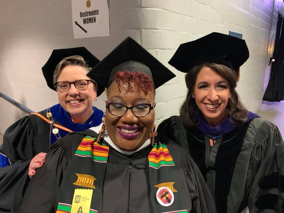 Tokeya Graham at graduation ceremony with colleagues